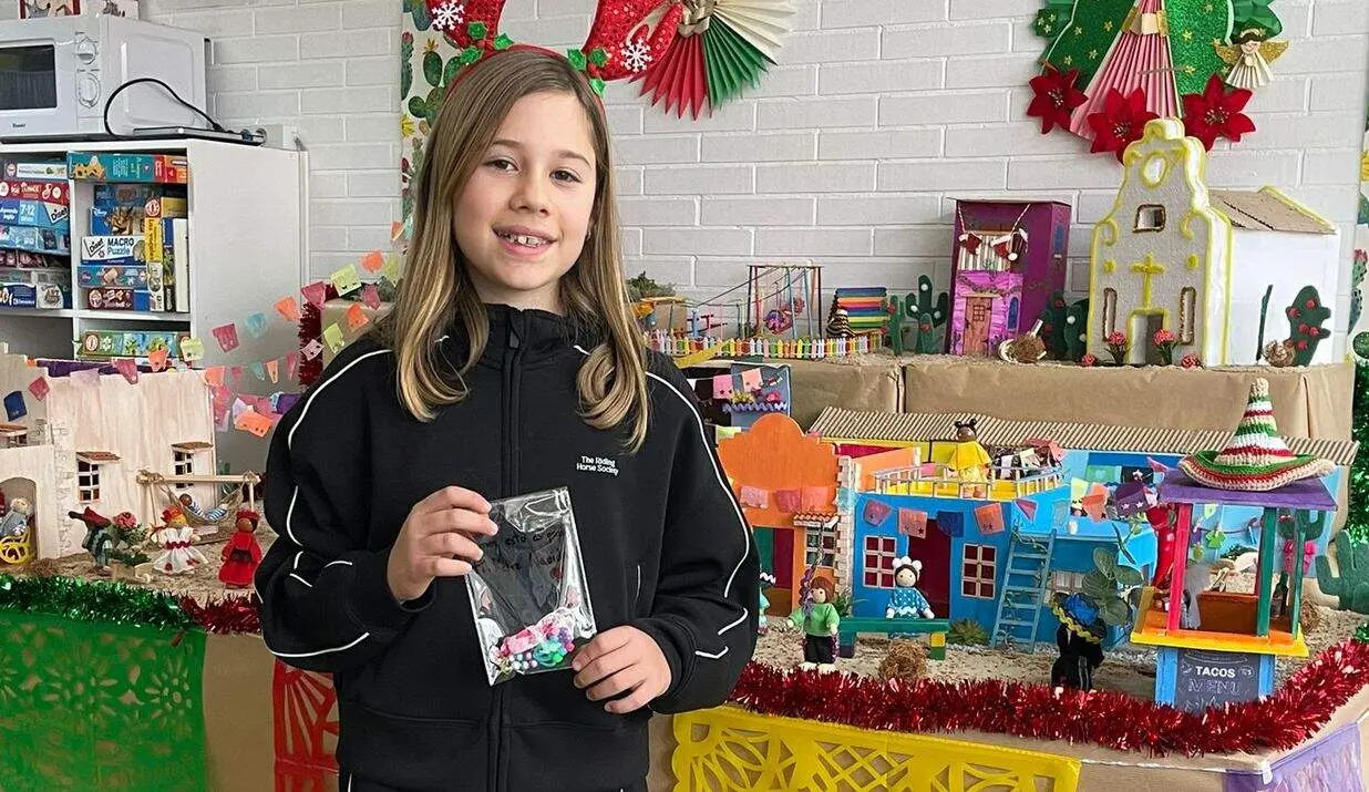 Adriana con una de sus pulseras hechas a mano frente al bel&eacute;n de la Sala de Juegos de Pediatr&iacute;a de la Gasbi 1