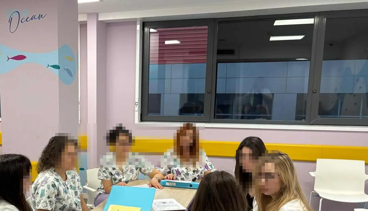 Equipo m&eacute;dico del &aacute;rea de psiquiatr&iacute;a infantil junto a los ventanales de seguridad habilitados en la segunda planta, cuarta de un inmueble convencional.