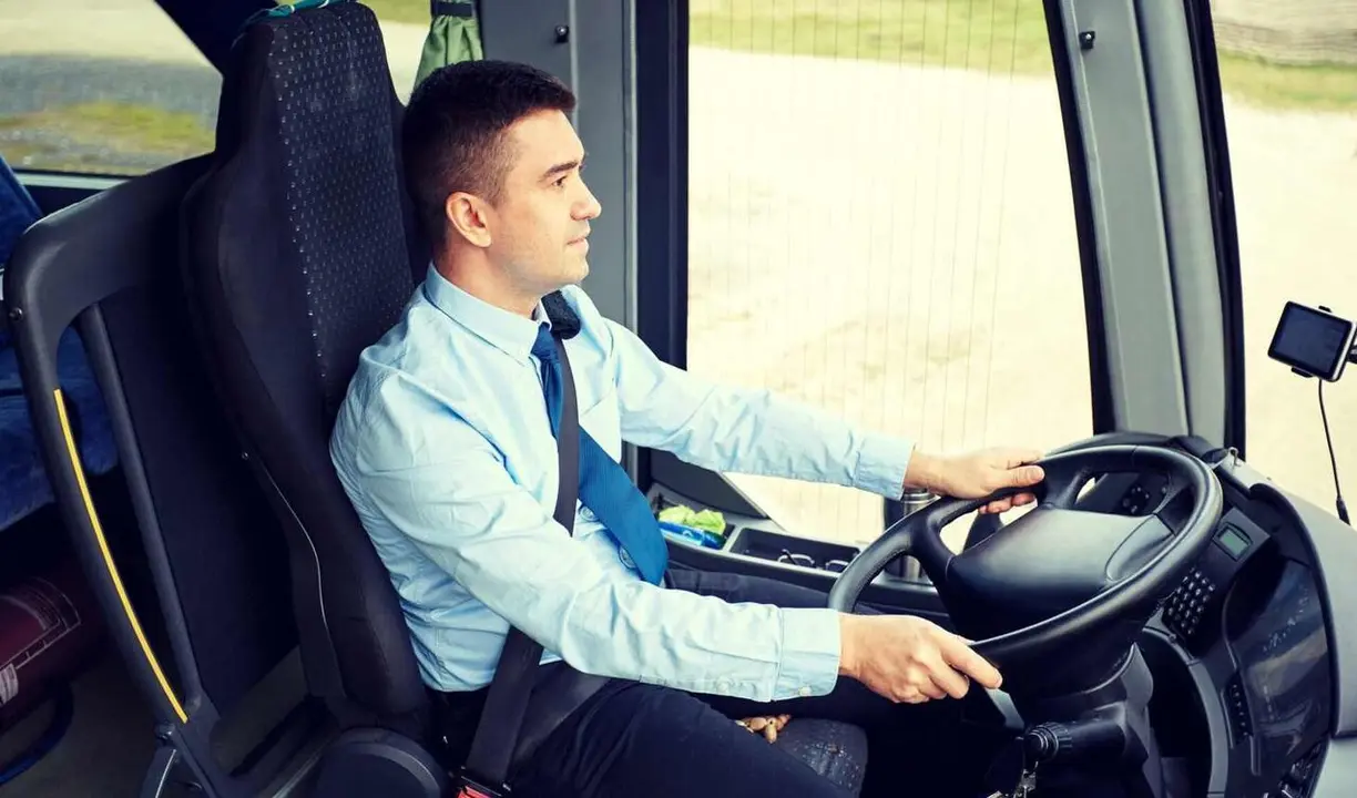 transport, tourism, road trip and people concept - happy driver driving intercity bus