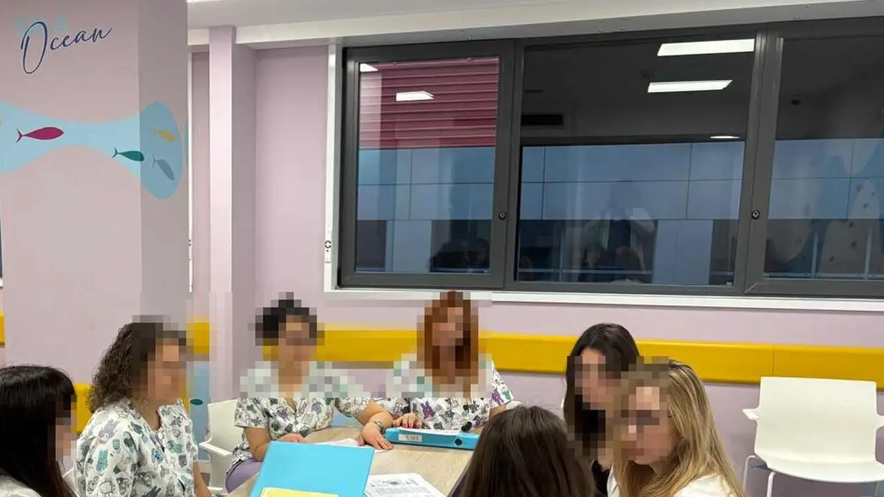 Equipo m&eacute;dico del &aacute;rea de psiquiatr&iacute;a infantil junto a los ventanales de seguridad habilitados en la segunda planta, cuarta de un inmueble convencional.