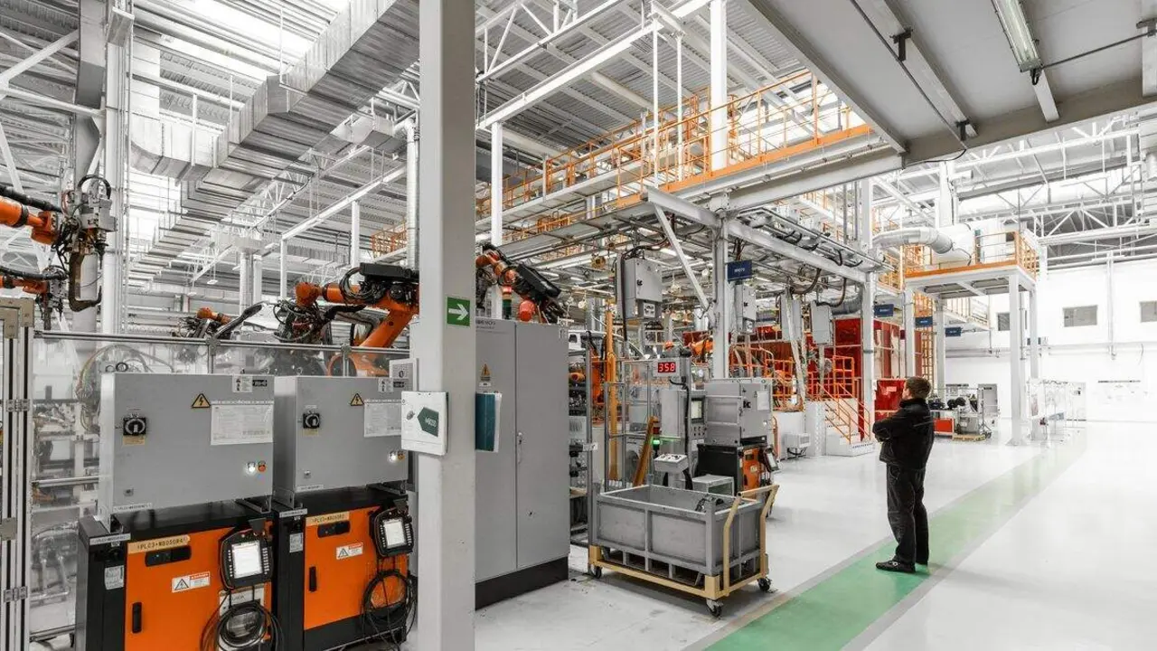 Photo of automobile production line. Welding car body. Modern car assembly plant. Auto industry. Interior of a high-tech factory, modern production.