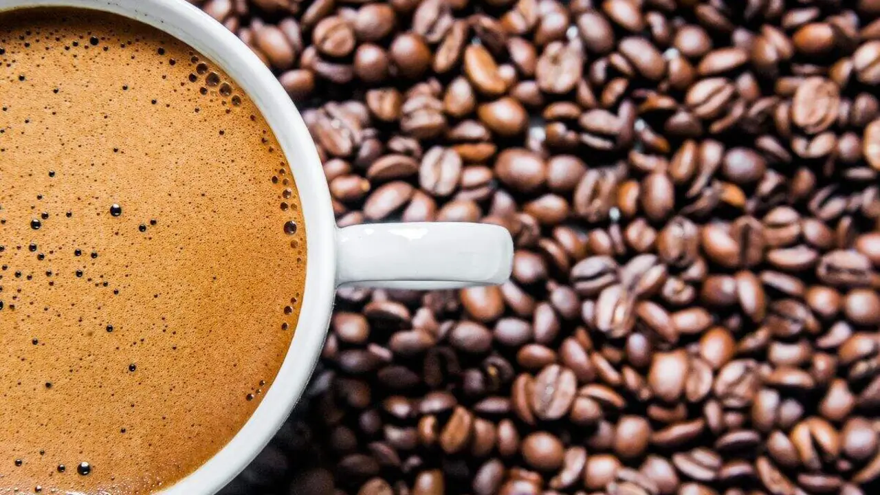 Coffee cup and coffee beans on table, top view, love coffee, Brown coffee beans isolated on white background, Hot Coffee cup with Coffee beans