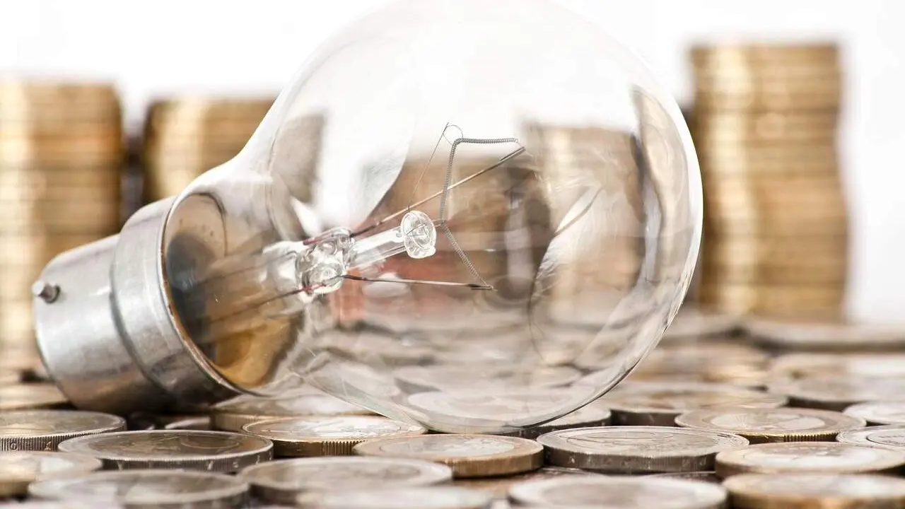 filament bulb lying on euro coins