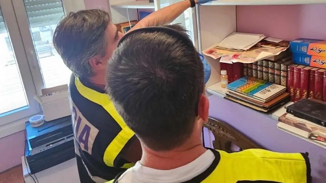 Efectivos de la Polic&iacute;a Nacional junto al cartucho de dinamita localizado en la vivienda.
