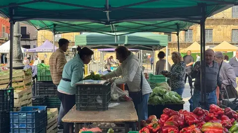 María Jesús atendiendo en su puesto de pimientos del mercado tradicional de la Plaza Mayor.