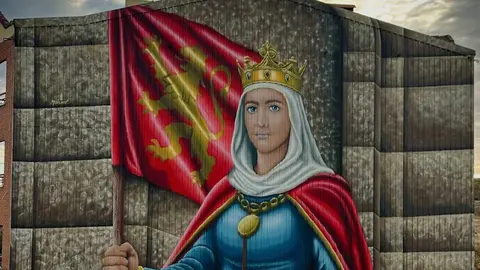 Sahagún rinde homenaje a la reina Urraca con un mural monumental como antesala del 900 aniversario de su muerte
Sahagún rinde homenaje a la reina Urraca con un mural monumental como antesala del 900 aniversario de su muerte. El artista leonés Manuel García Juan firma una obra de gran formato que representa a la primera reina de pleno derecho de España y Europa.