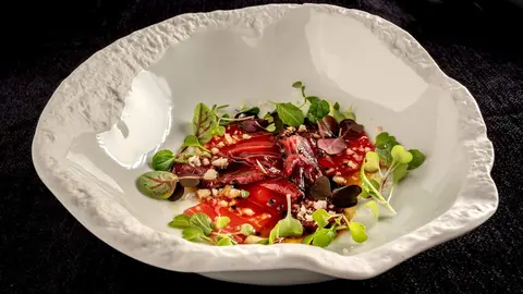 Carpaccio de solomillo de buey, lomo de atún y nuez de macadamia.